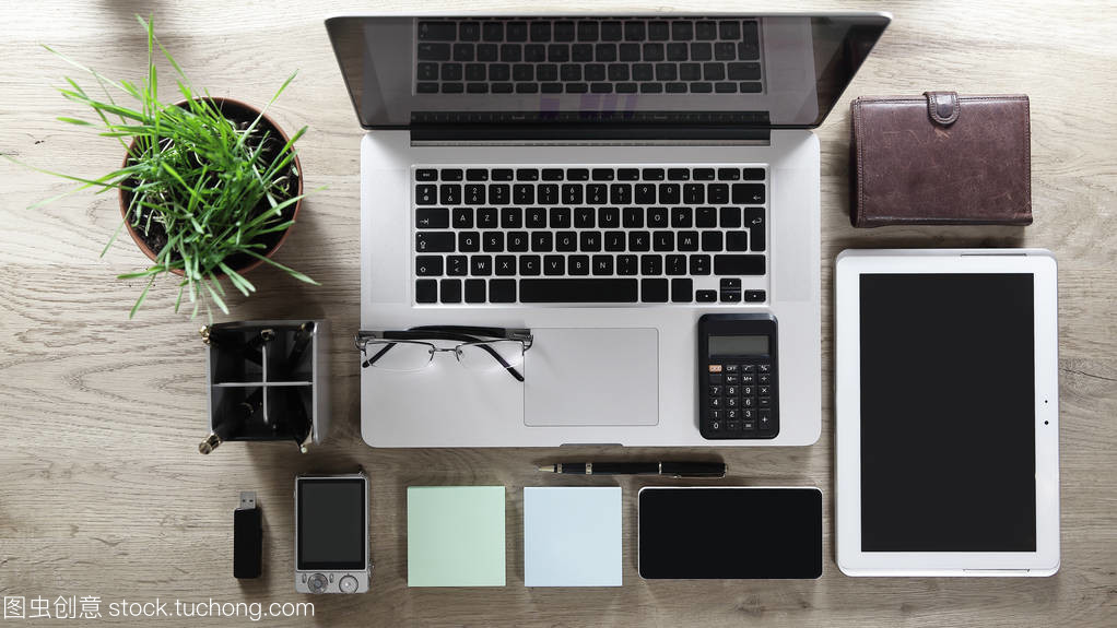 木桌之上 办公设备、眼镜与用品的秩序美学